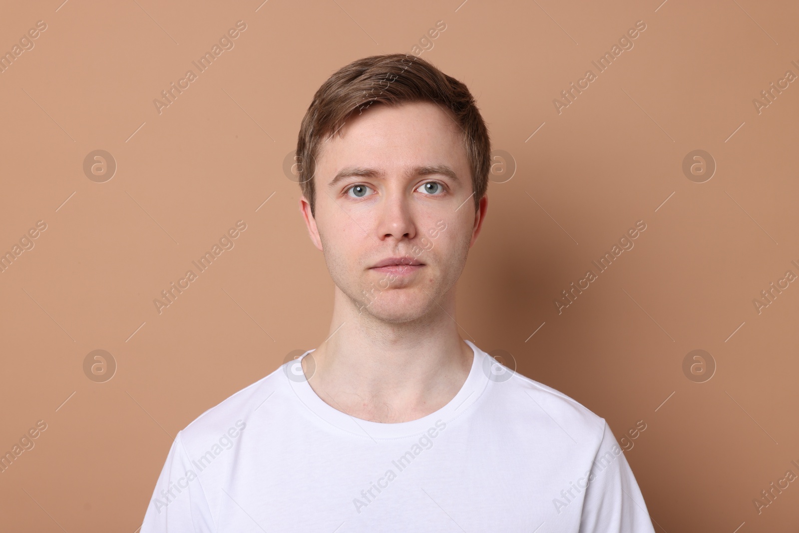 Handsome man after shaving on beige background Photo of Handsome man after shaving on beige background