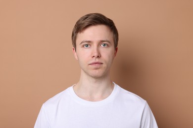Photo of Handsome man after shaving on beige background