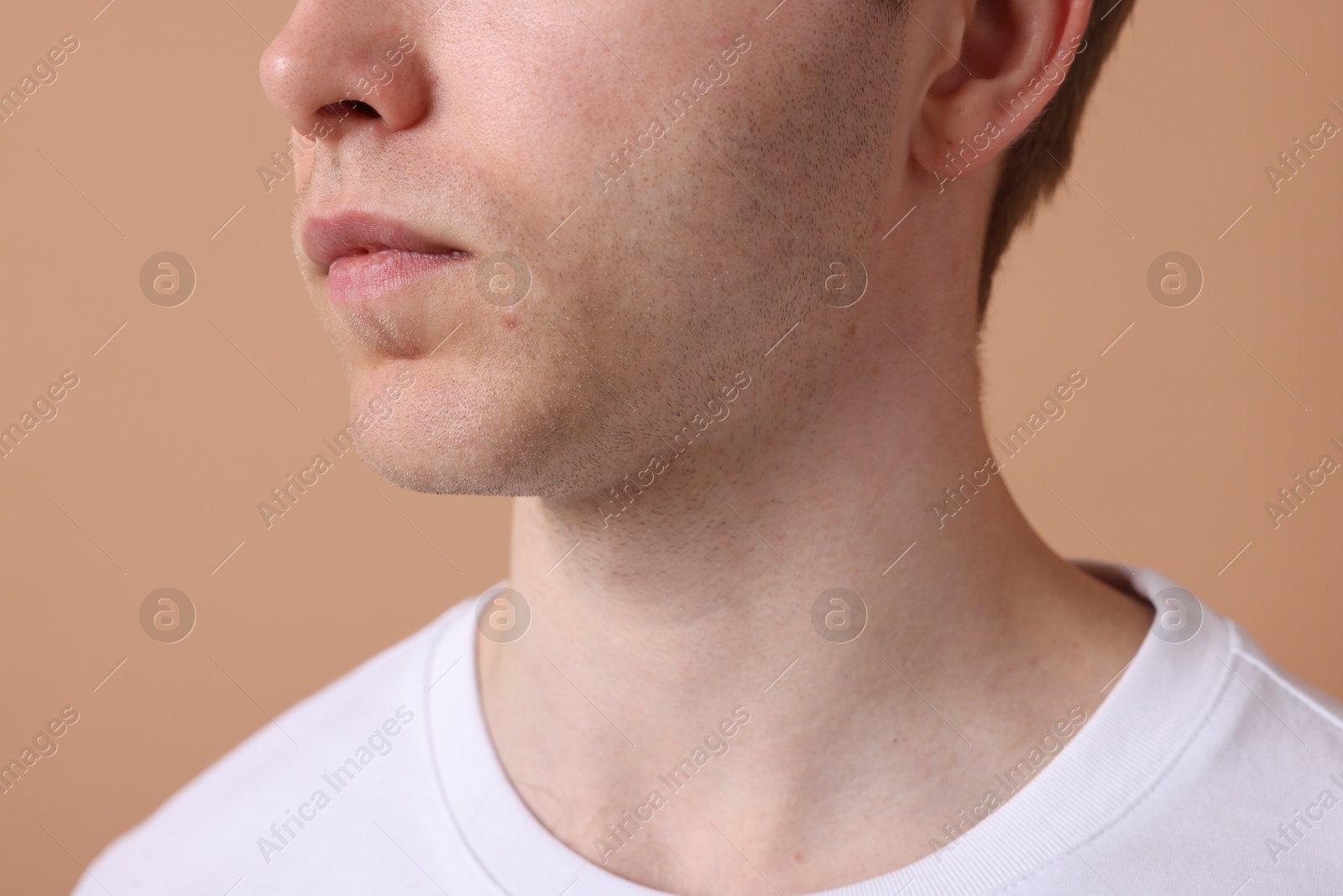 Man after shaving on beige background, closeup Photo of Man after shaving on beige background, closeup