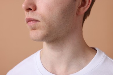 Photo of Man after shaving on beige background, closeup