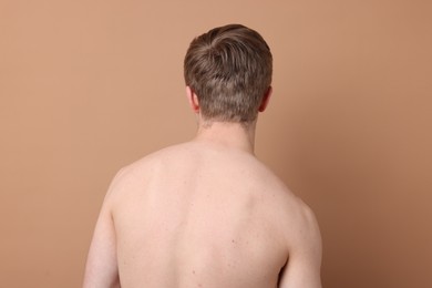 Photo of Man before scoliosis treatment on beige background, back view