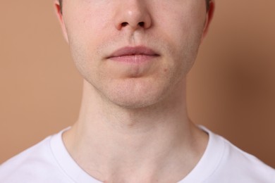 Photo of Man after shaving on beige background, closeup