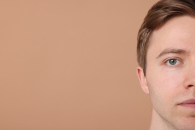 Photo of Man after shaving on beige background, closeup. Space for text