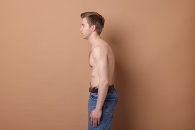 Photo of Man before scoliosis treatment on beige background