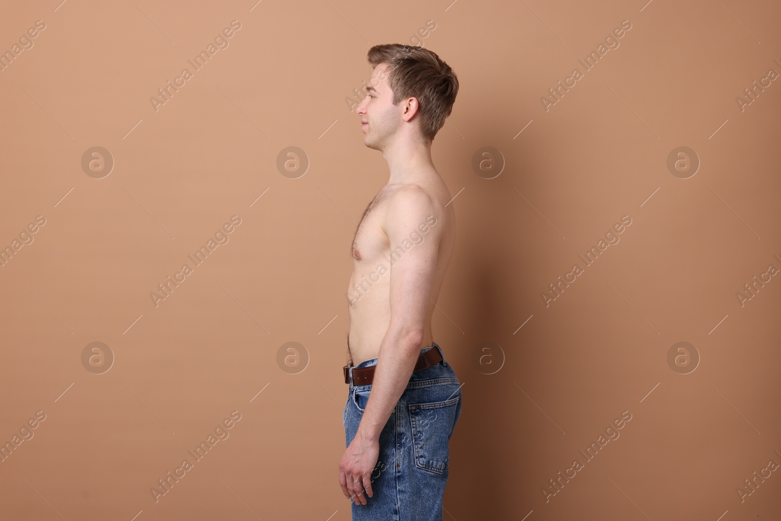 Man after scoliosis treatment on beige background Photo of Man after scoliosis treatment on beige background
