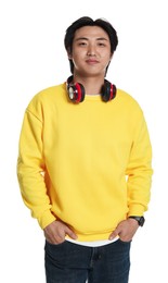 Photo of Portrait of handsome Asian man with headphones on white background