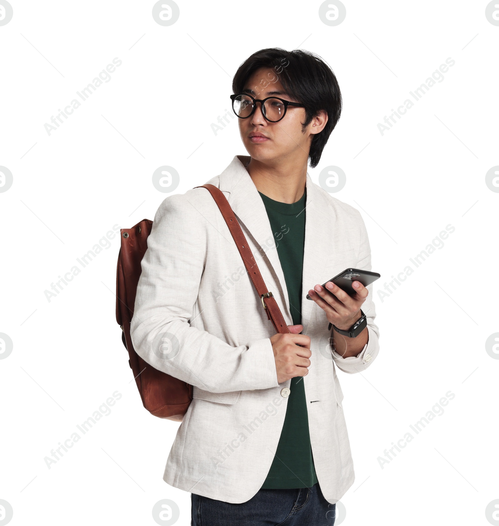 Portrait of handsome Asian man in glasses with smartphone and backpack on white background Photo of Portrait of handsome Asian man in glasses with smartphone and backpack on white background