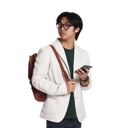Photo of Portrait of handsome Asian man in glasses with smartphone and backpack on white background