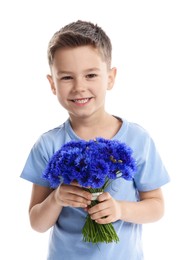 Photo of Smiling little boy with bouquet of beautiful cornflowers on white background