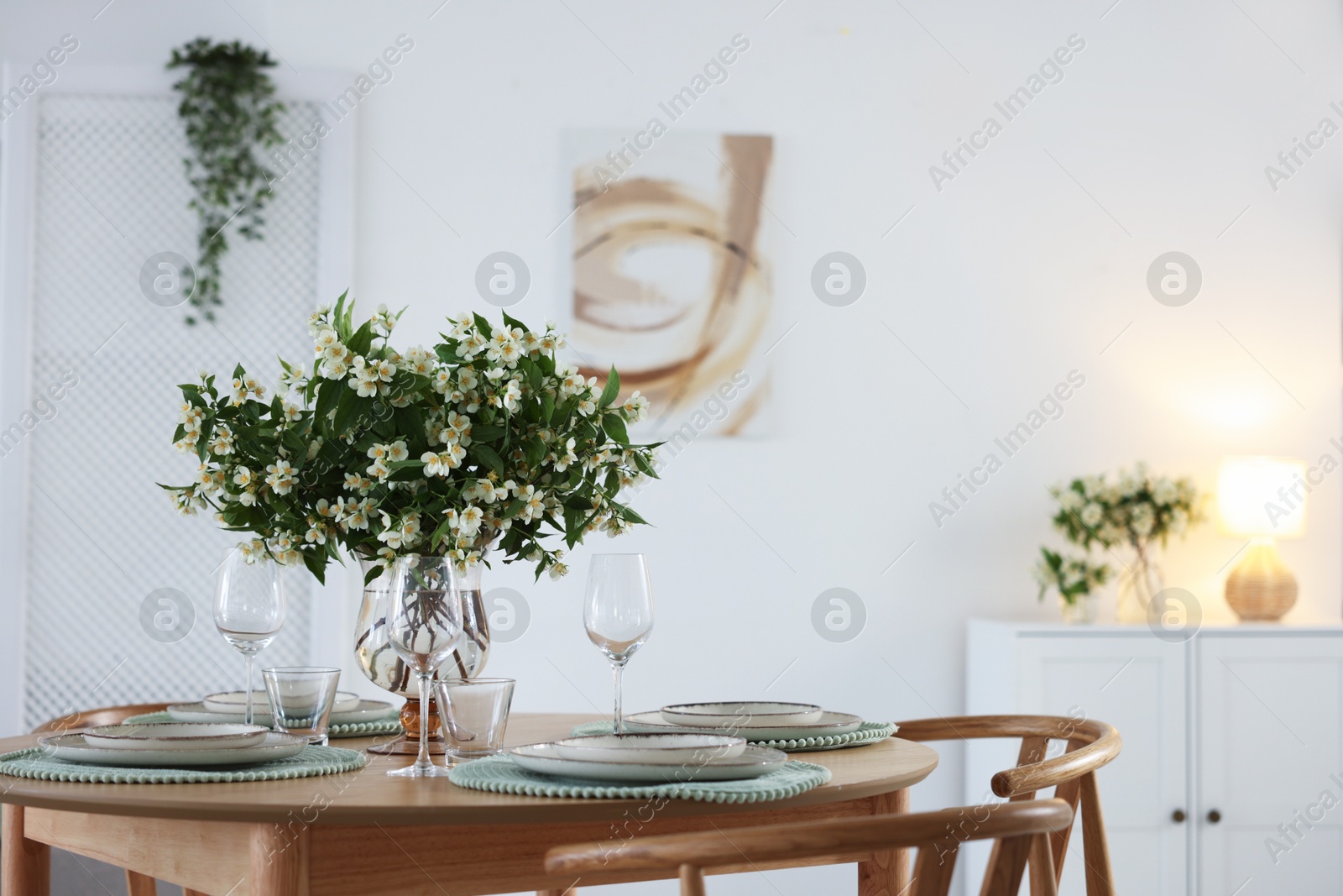 Bouquet of beautiful jasmine flowers on dining table indoors. Space for text Photo of Bouquet of beautiful jasmine flowers on dining table indoors. Space for text