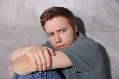 Photo of Scared man suffering from paranoia at home