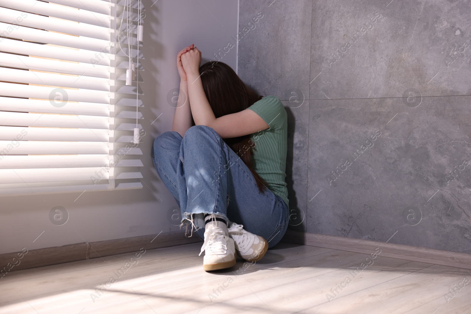 Woman suffering from paranoia near window at home Photo of Woman suffering from paranoia near window at home