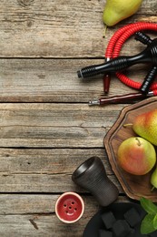 Photo of Hookah, coal and fresh fruits on wooden table, flat lay. Space for text