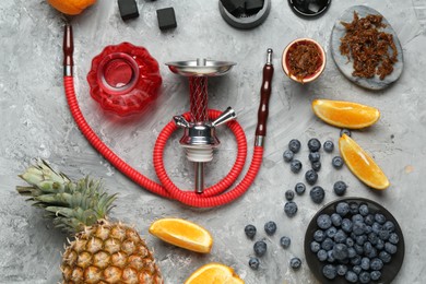 Photo of Hookah, coal and fresh fruits on grey table, flat lay