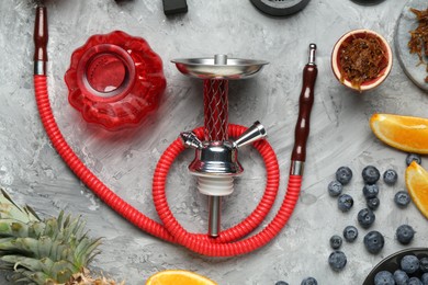Photo of Hookah and fresh fruits on grey table, flat lay