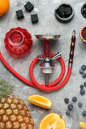 Photo of Hookah, coal and fresh fruits on grey table, flat lay