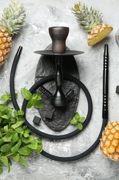 Photo of Hookah, coal and fresh fruits on grey table, flat lay