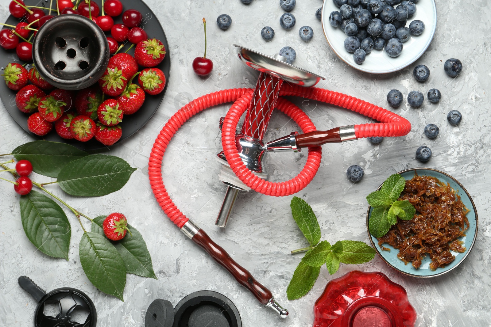 Photo of Hookah and fresh fruits on grey table, flat lay