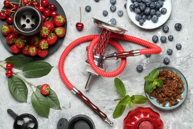 Photo of Hookah and fresh fruits on grey table, flat lay