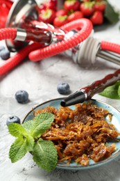Photo of Hookah and fresh fruits on grey table, closeup