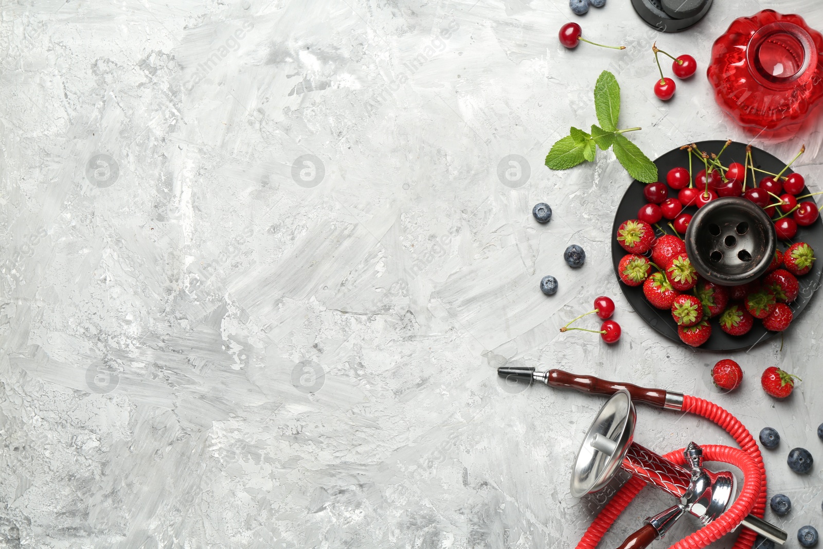 Photo of Hookah and fresh fruits on grey table, flat lay. Space for text