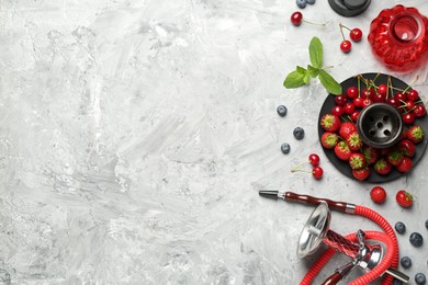 Photo of Hookah and fresh fruits on grey table, flat lay. Space for text
