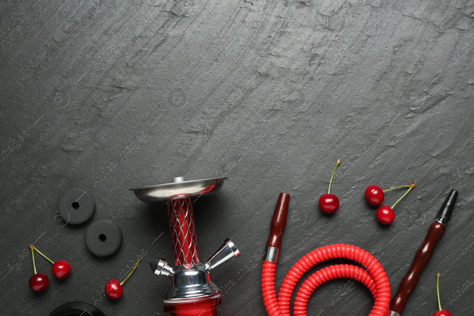 Photo of Hookah and cherries on black table, flat lay. Space for text