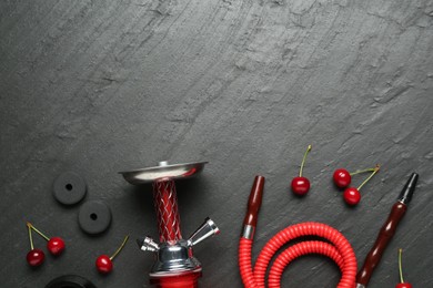 Photo of Hookah and cherries on black table, flat lay. Space for text