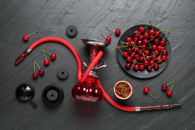 Photo of Hookah and cherries on black table, flat lay