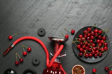 Photo of Hookah and cherries on black table, flat lay. Space for text