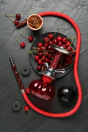 Photo of Hookah and cherries on black table, flat lay