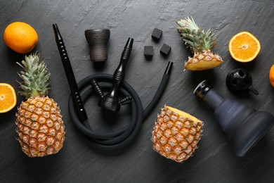 Photo of Hookah, coal and fresh fruits on black table, flat lay