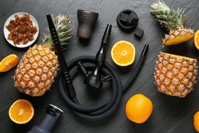 Photo of Hookah, coal and fresh fruits on black table, flat lay