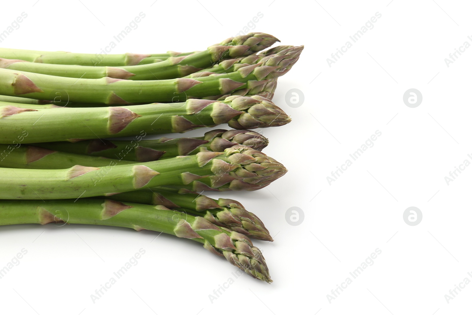 Fresh raw asparagus spears isolated on white Photo of Fresh raw asparagus spears isolated on white