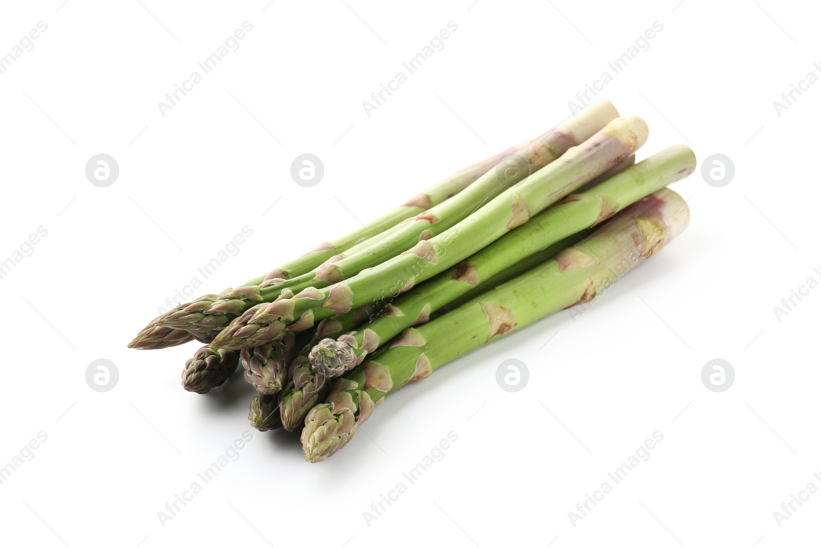 Fresh raw asparagus spears isolated on white Photo of Fresh raw asparagus spears isolated on white