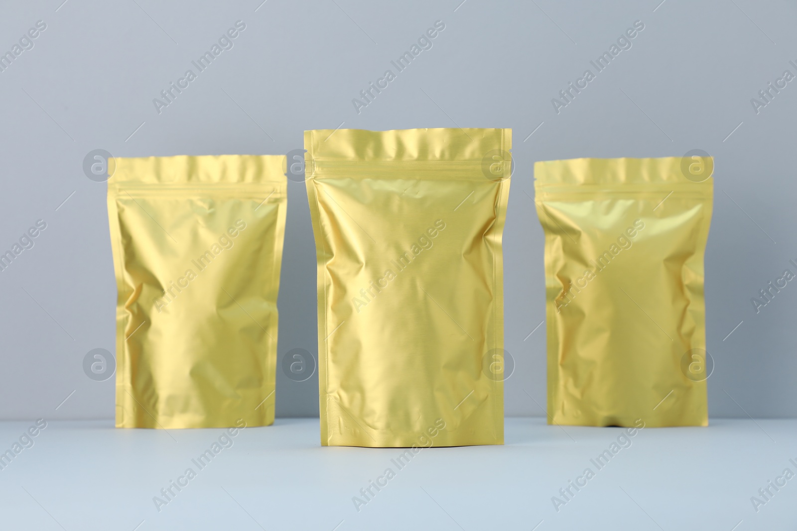 Zipper stand-up pouches on light grey background. Mockup for design Photo of Zipper stand-up pouches on light grey background. Mockup for design