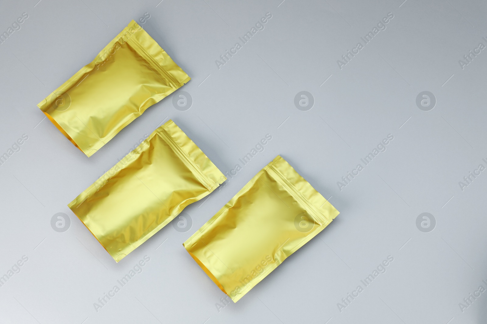 Zipper stand-up pouches on light grey background, flat lay. Mockup for design Photo of Zipper stand-up pouches on light grey background, flat lay. Mockup for design