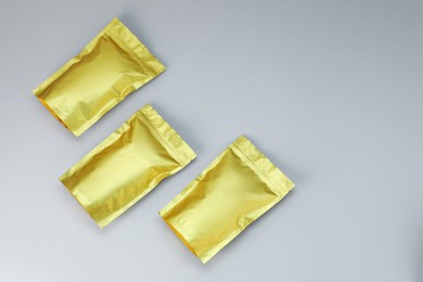 Photo of Zipper stand-up pouches on light grey background, flat lay. Mockup for design