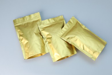 Photo of Zipper stand-up pouches on light grey background, flat lay. Mockup for design