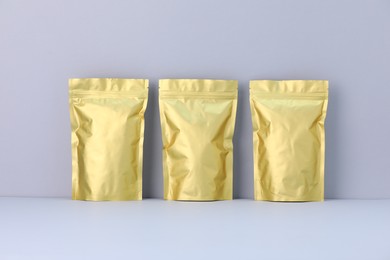 Photo of Zipper stand-up pouches on light grey background. Mockup for design