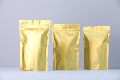 Photo of Zipper stand-up pouches on light grey background. Mockup for design