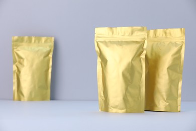 Photo of Zipper stand-up pouches on light grey background. Mockup for design