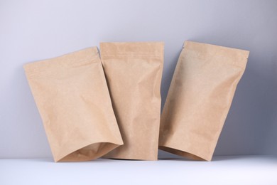 Photo of Zipper stand-up pouches on light grey background. Mockup for design