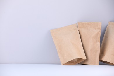 Photo of Zipper stand-up pouches on light grey background. Mockup for design