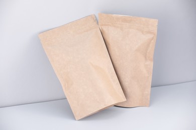 Photo of Zipper stand-up pouches on light grey background. Mockup for design