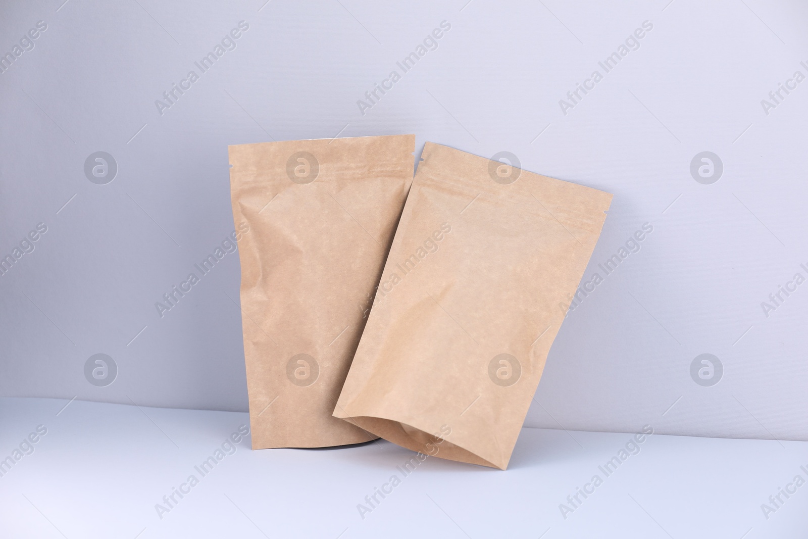 Zipper stand-up pouches on light grey background. Mockup for design Photo of Zipper stand-up pouches on light grey background. Mockup for design