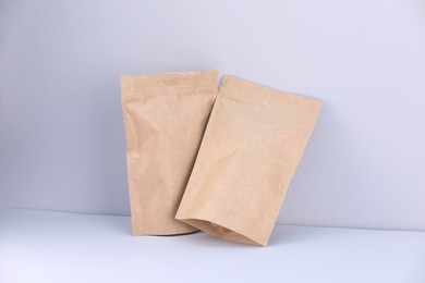 Photo of Zipper stand-up pouches on light grey background. Mockup for design