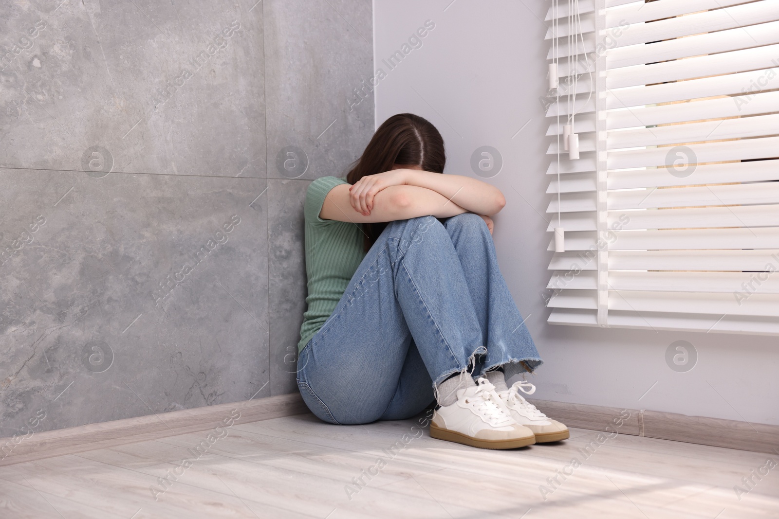 Woman suffering from paranoia near window at home Photo of Woman suffering from paranoia near window at home