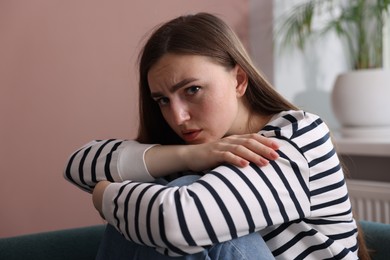 Photo of Worried woman suffering from paranoia at home