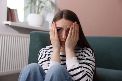 Photo of Worried woman suffering from paranoia at home